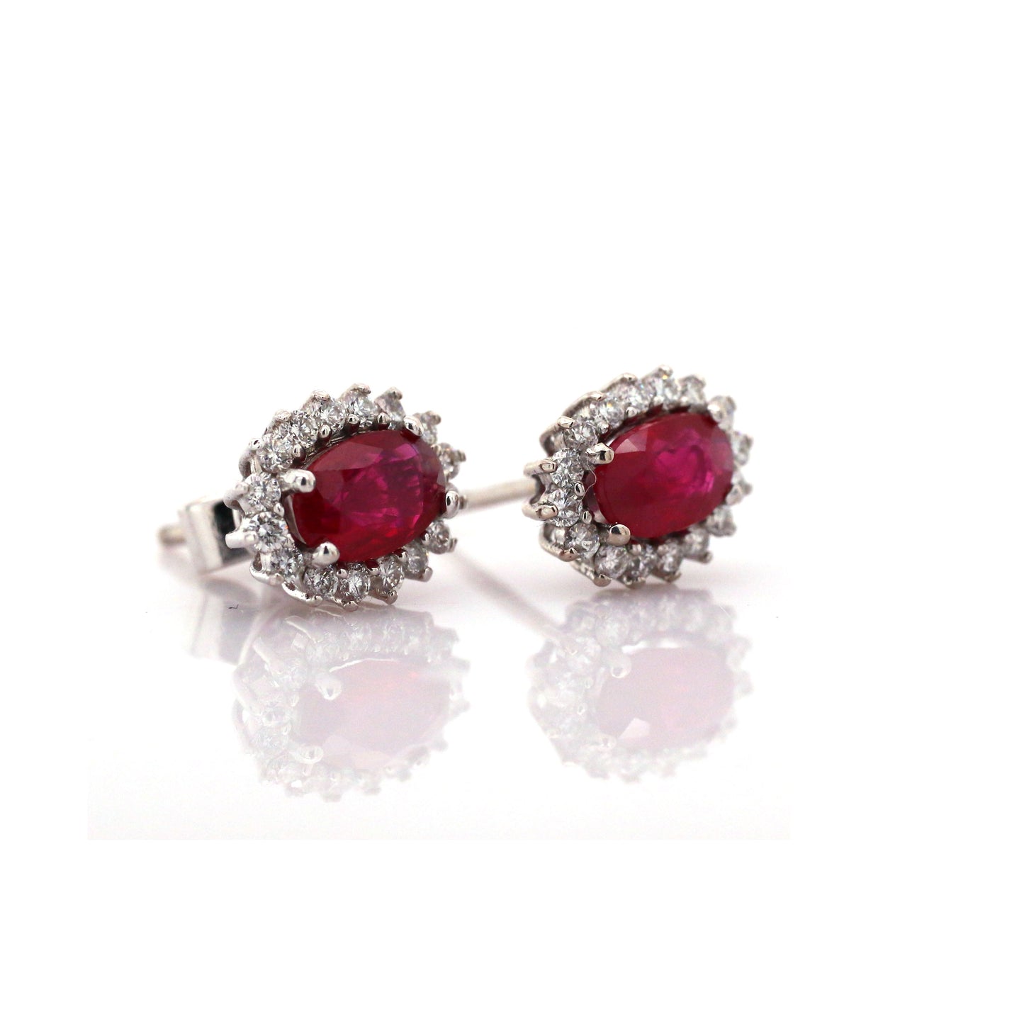 Beautiful and Almost Flawless ruby has been Elegantly set with Natural Diamonds to create this 18kt White Gold Earring.