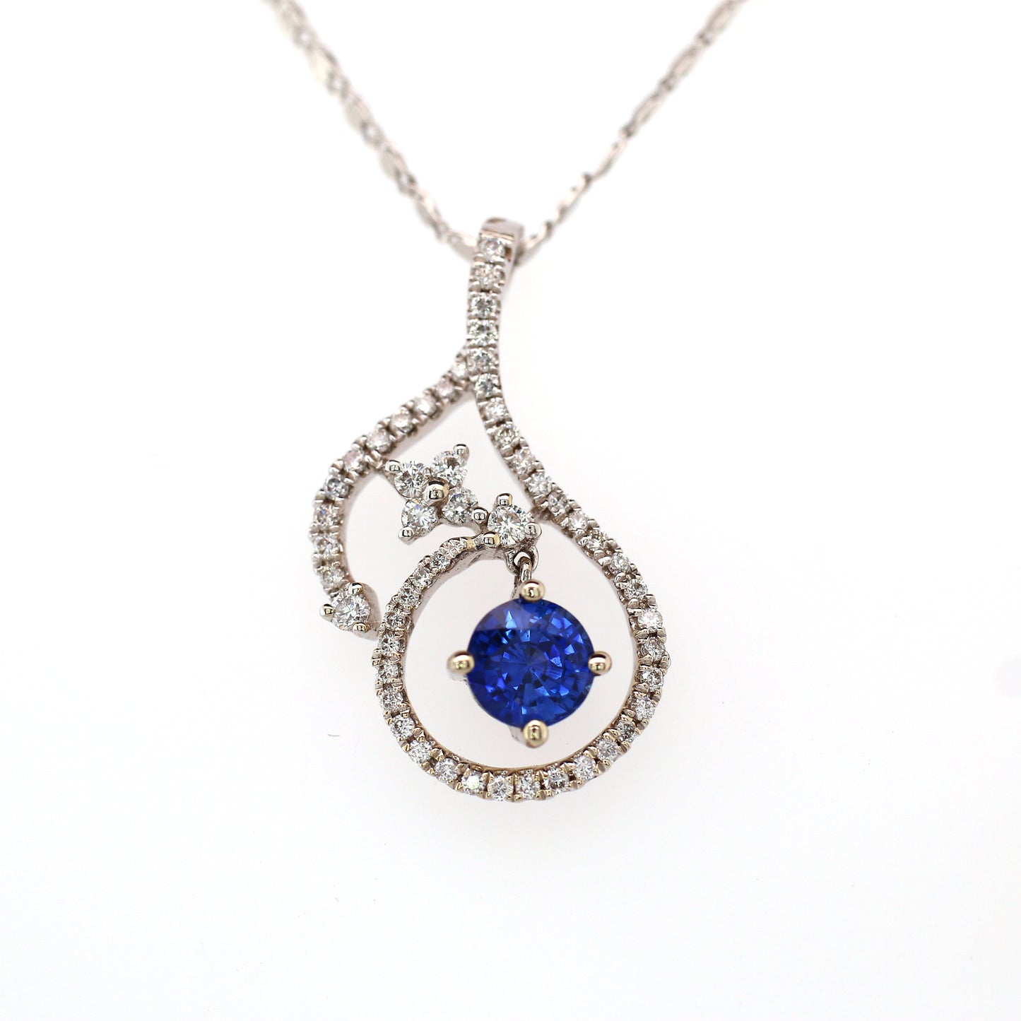 Vivid Blue Sapphire has been Elegantly set with Natural Diamonds to create this 18kt White Gold Pendant.