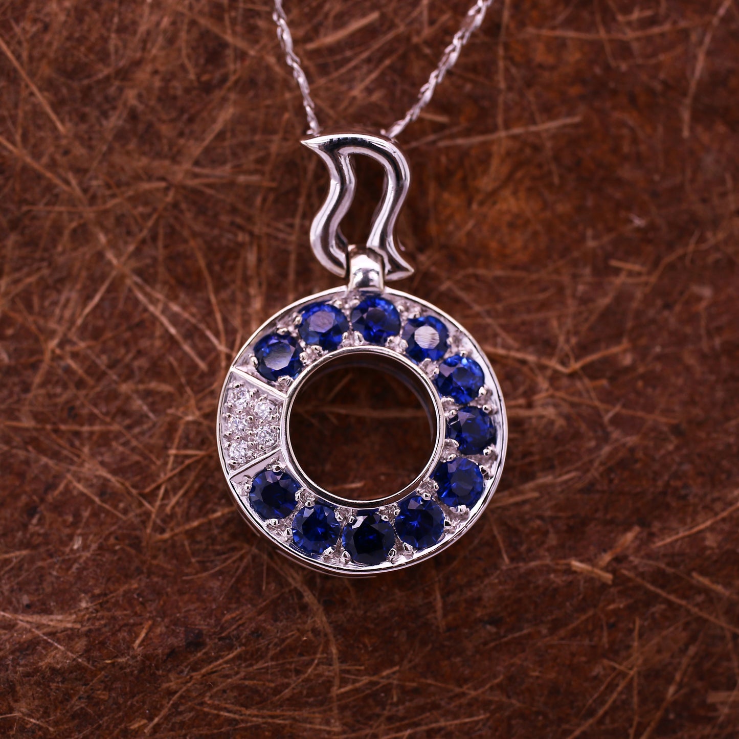 Round Blue Sapphires & Brilliant Diamonds Pendant in a cool pattern Mounted in 18k White Gold.