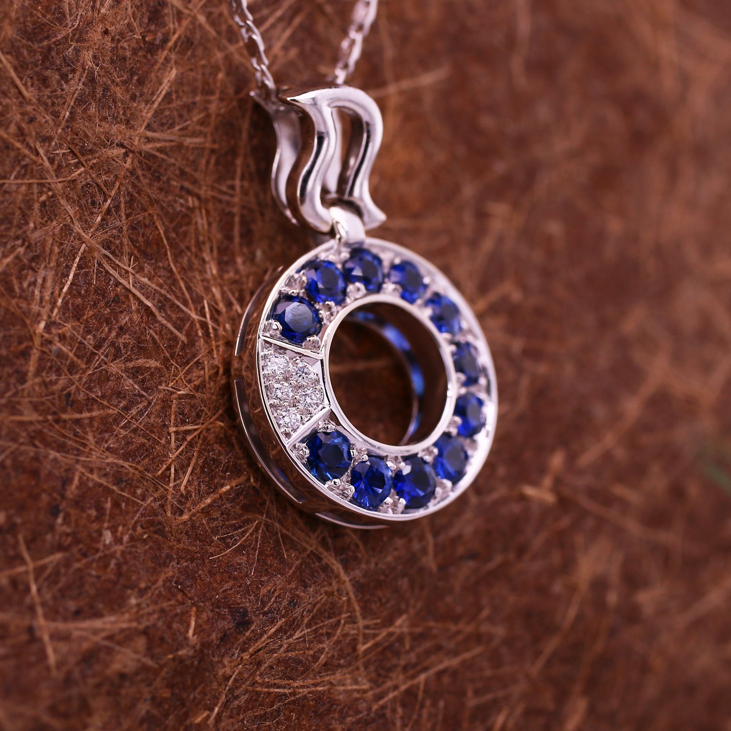 Round Blue Sapphires & Brilliant Diamonds Pendant in a cool pattern Mounted in 18k White Gold.