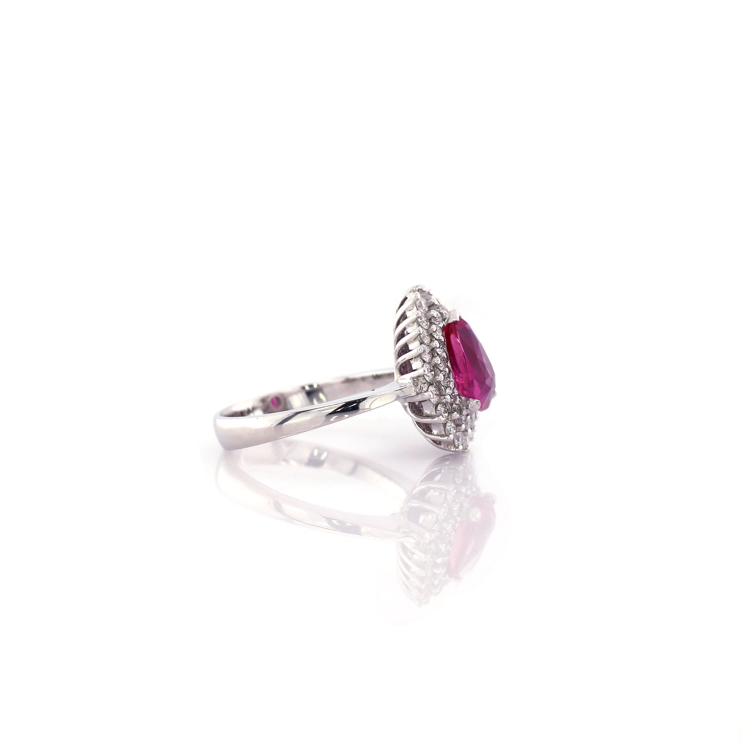 In this stunning estate jewel, a beautifully modeled pear shape Ceylon Ruby with Halo Diamonds