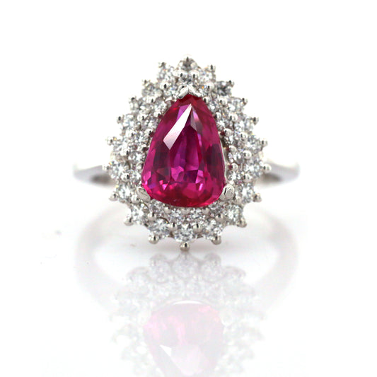 In this stunning estate jewel, a beautifully modeled pear shape Ceylon Ruby with Halo Diamonds