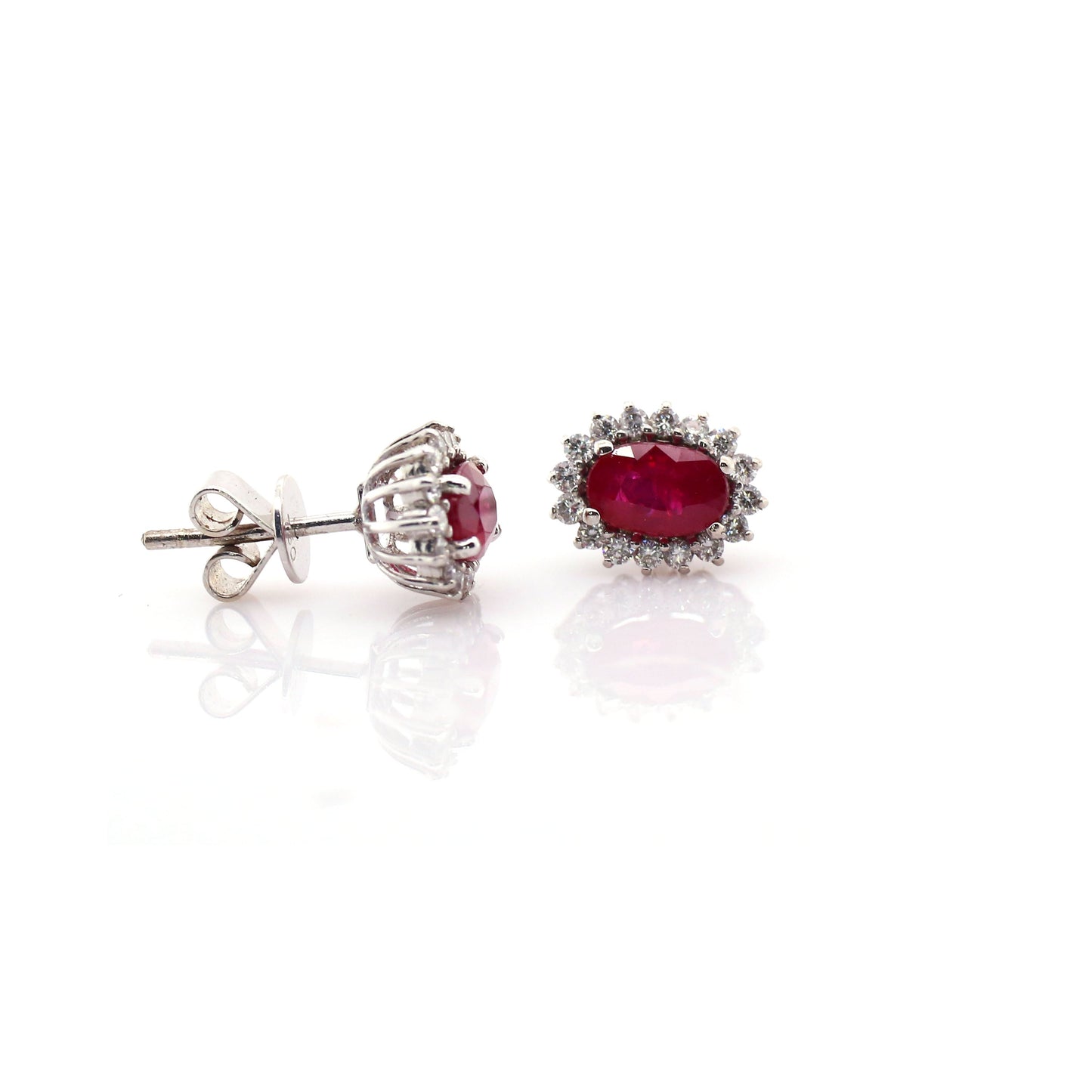 Beautiful and Almost Flawless ruby has been Elegantly set with Natural Diamonds to create this 18kt White Gold Earring.