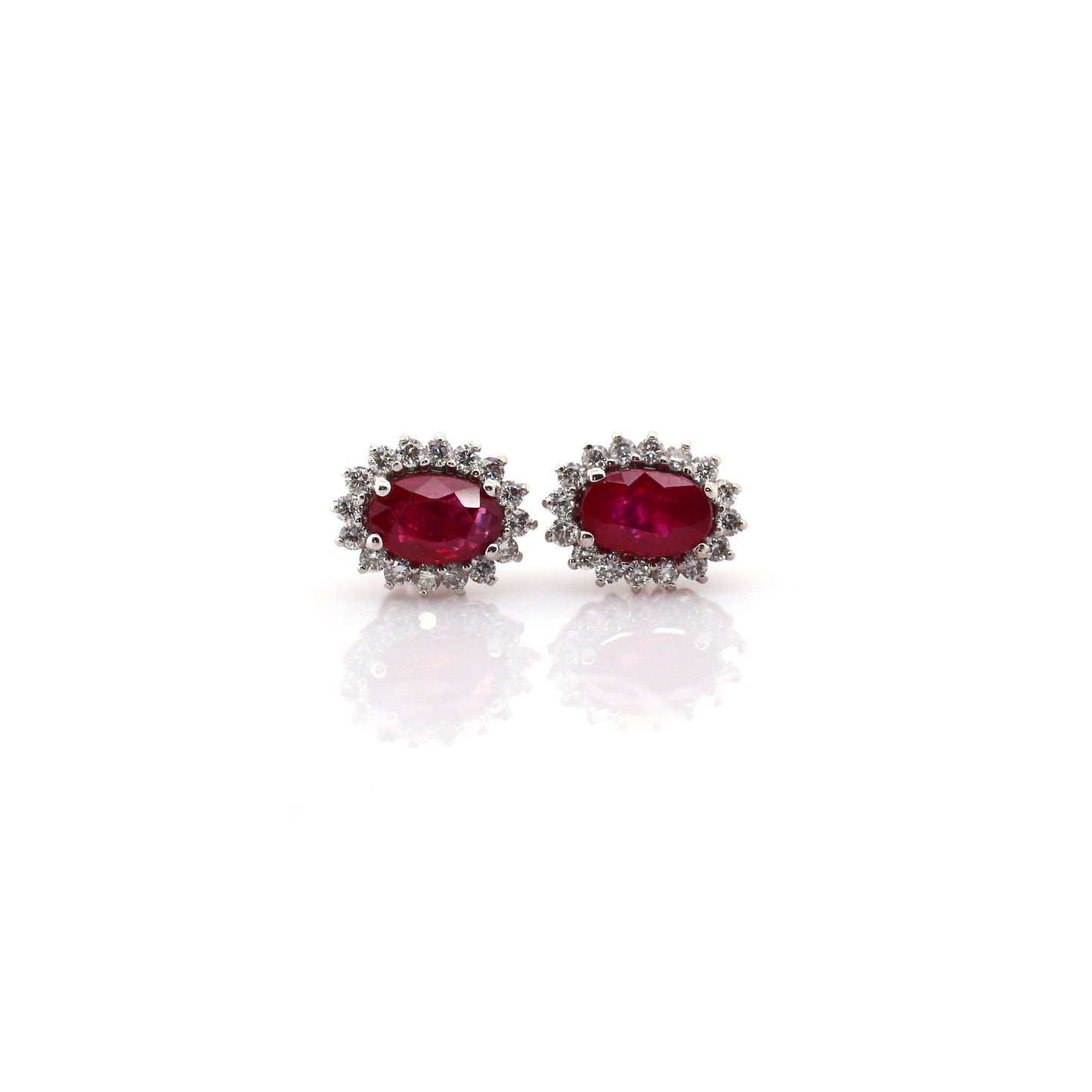 Beautiful and Almost Flawless ruby has been Elegantly set with Natural Diamonds to create this 18kt White Gold Earring.