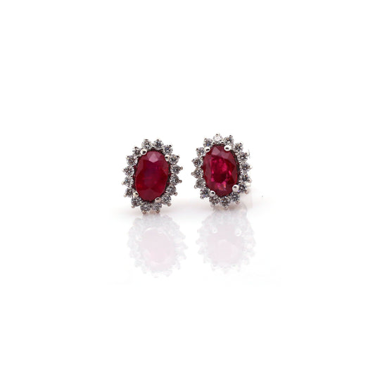 Beautiful and Almost Flawless ruby has been Elegantly set with Natural Diamonds to create this 18kt White Gold Earring.