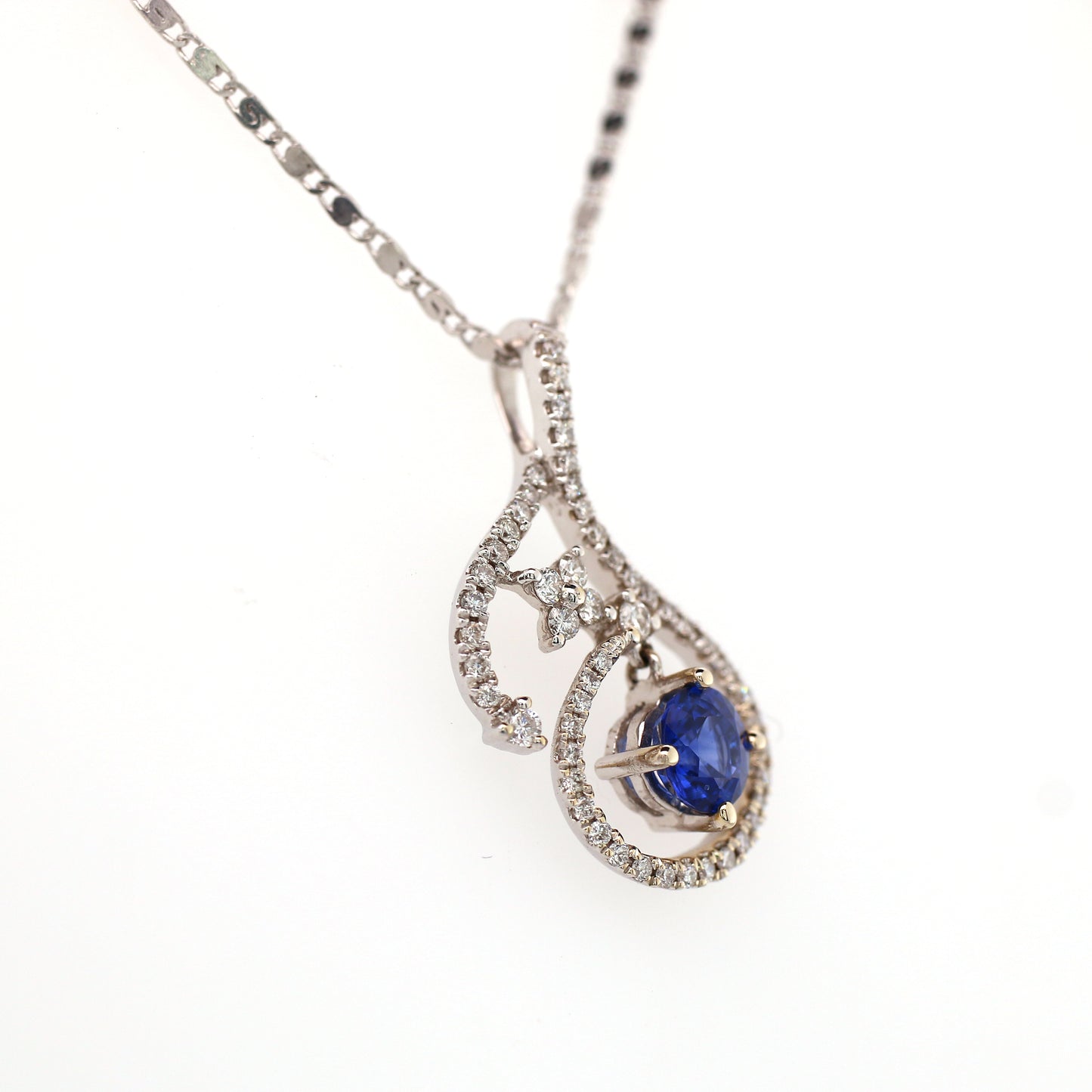 Vivid Blue Sapphire has been Elegantly set with Natural Diamonds to create this 18kt White Gold Pendant.