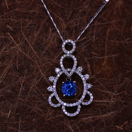Blue sapphire and diamond stud pendant in 18K white gold