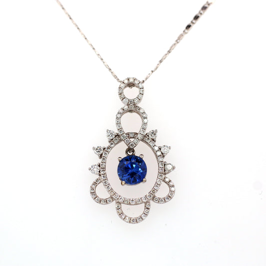 Natural Blue Sapphire pendant in 18K White Gold. It has a Round Faceted cut Sapphire studded with halo of diamonds that completes your look with a decent touch.