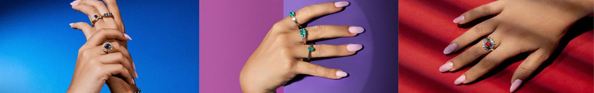Hands wearing gemstone rings against cobalt, violet and red backdrops